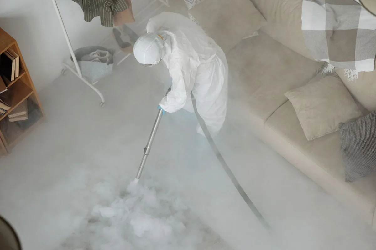 Biohazard cleanup technician in protective equipment, Crouch Mesa, NM